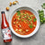 bottle of tongue in peat smoked tomato juice next to a bowl of gazpacho soup