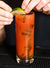 glass of mezcal maria cocktail, garnished with a slice or lime